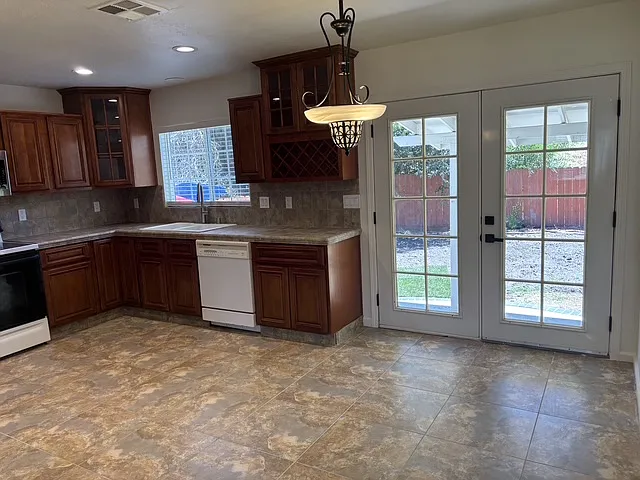 Additional view of immaculate kept kitchen with French Doors leading to the backyard. Space for eat-in kitchen table.