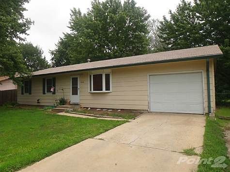 Driveway with attached garage and opener with extra parking on side.