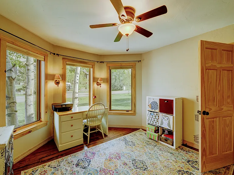 Bonus room or bedroom on main level with closet, and large windows letting plenty of light in.