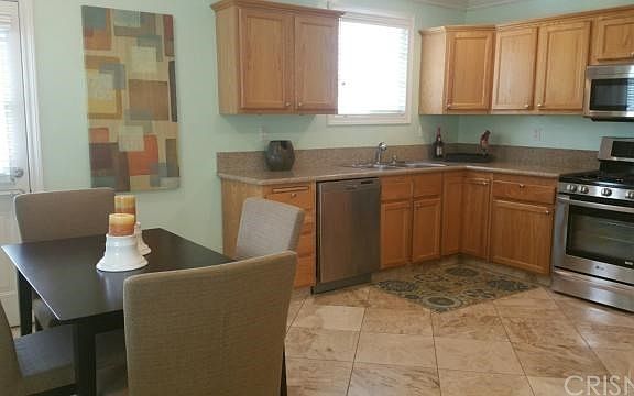 Kitchen with granite countertops and marble floors.