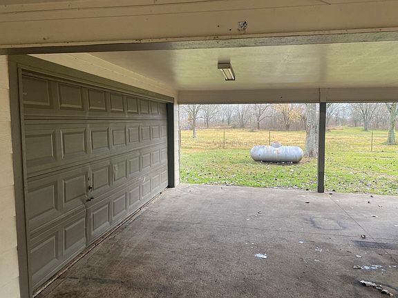 2 car garage with port a cache for acres of backyard viewing