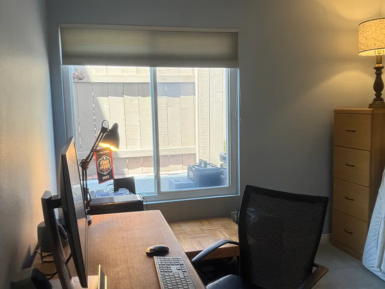 Downstairs bedroom is currently being used as an office. The bathroom is just across the hall. Floor to ceiling mirrors closets currently have shelves that are easily removed.