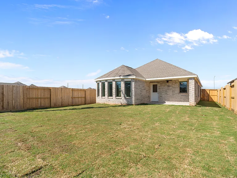 Full rear view of home with covered back patio, privacy fence enclosing a large backyard AA?A? plenty of room to relax and entertain.