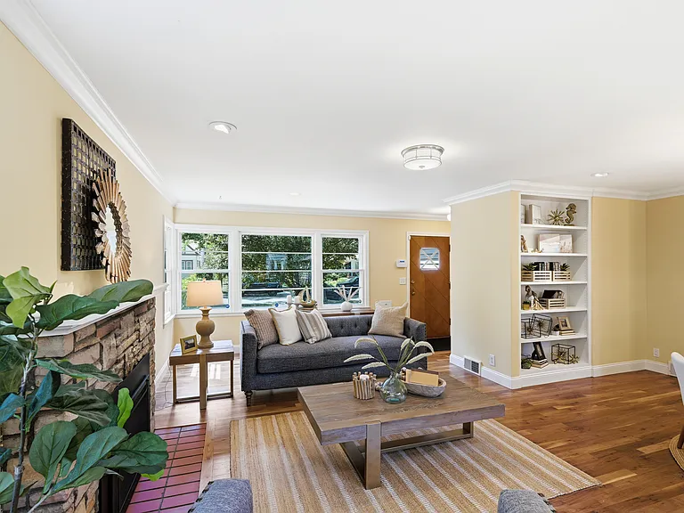 View of living area from east to west, facing Abbott Ave., fireplace on your left, dining area to your right