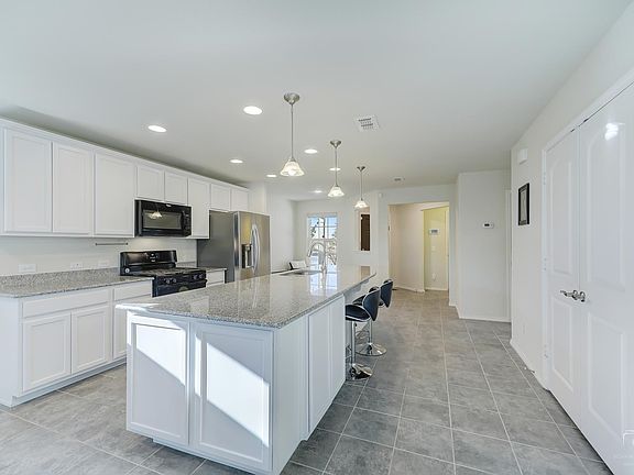 View of the kitchen back to the front of the house.