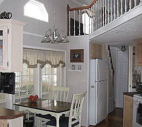 Eat-in kitchen boasts bay window in dining area. Note the loft above -- the perfect play/sleep space for the kids or grandkids, and/or for storing your odds and ends!