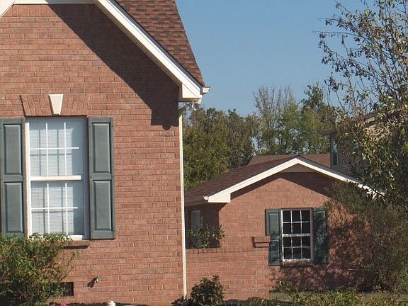 Matching Brick storage shed on slab w/electricity!