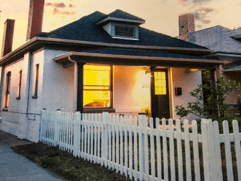 very cute bungalow with curb appeal with white picket fence