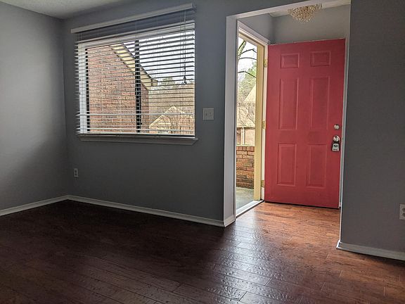 Picture window in living room looks out at the front porch.