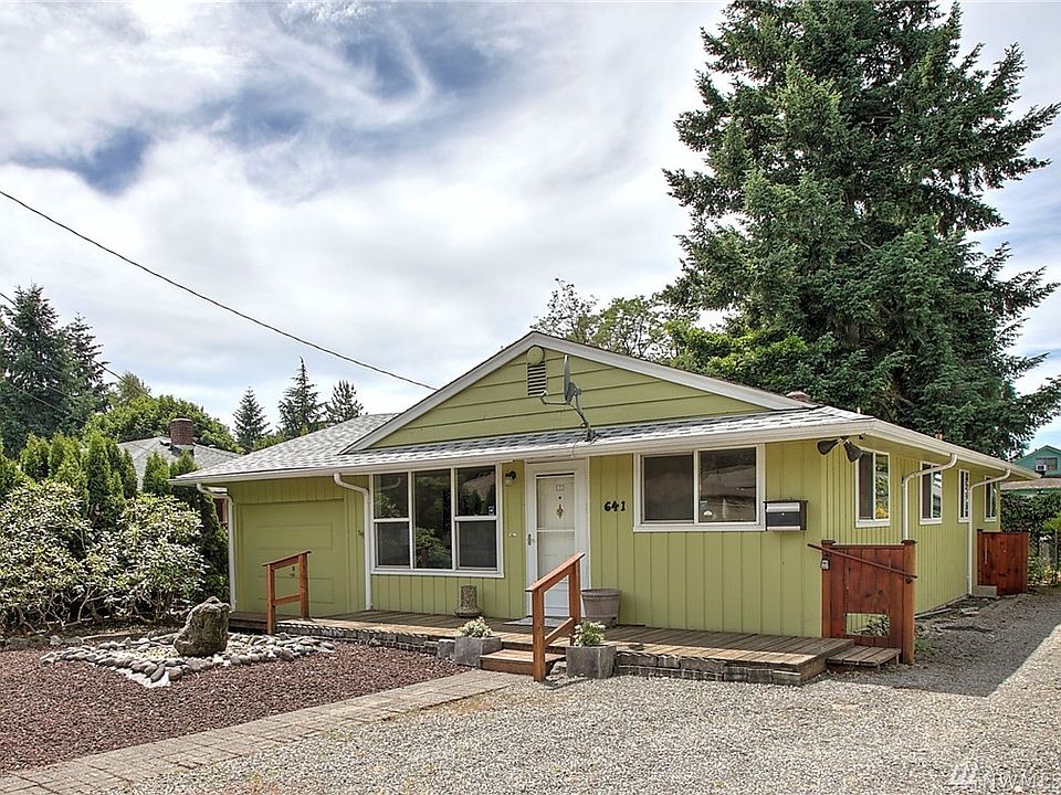 Welcome home to downtown Kent. This sweetheart rambler is located at the end of a quiet dead-end street and features 3 bedrooms, 1 bath, an updated kitchen and gorgeous landscape. A fountain and large deck in front provide charming curb appeal. Enter to the spacious living room with lovely picture window and peek-a-boo pass through to the kitchen. Gather in the updated kitchen with Corian counters, white appliances and high-end cabinet features. Extend your gatherings to the lush, expansive yard featuring a gorgeous wisteria arbor, patio, lovely perennial landscaping, a pond and more. The summer is just beginning to reveal all of its lovely surprises! You'll enjoy hardwood floors in the bedrooms and a large garage for additional storage. 