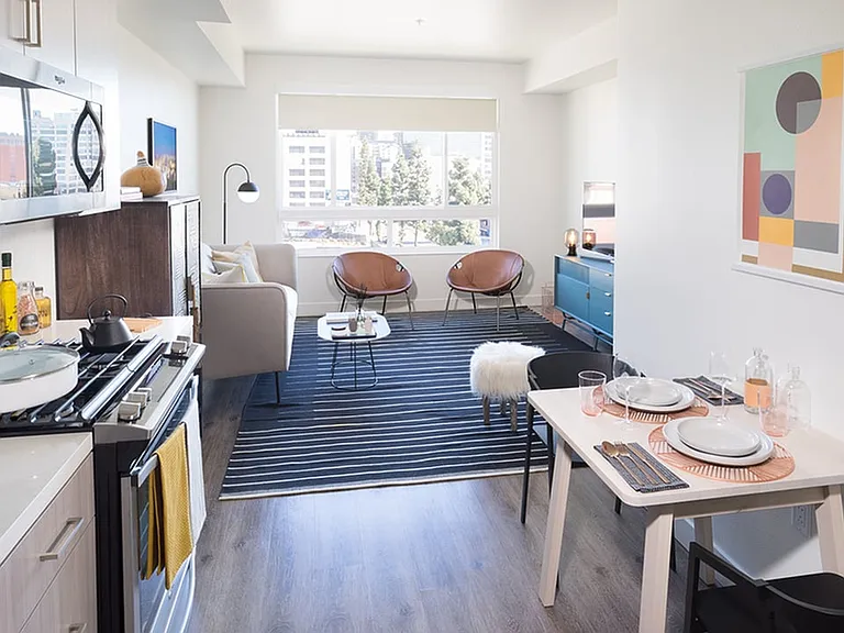 Gally kitchen with stainless steel appliances and stunning living room space
