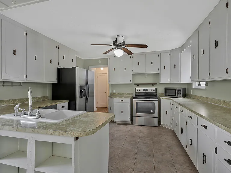 Photo 9. Open Kitchen with stainless steel appliances and lots of cabinets