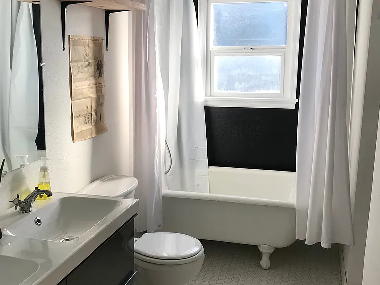 Bathroom with claw-foot tub and heated floors.