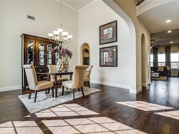 Light and bright entry and formal dining room greet you as you enter the home. Notice the ample wood flooring and with tall ceilings and lots of natural light!