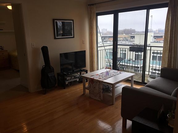 Living room with small TV and console.