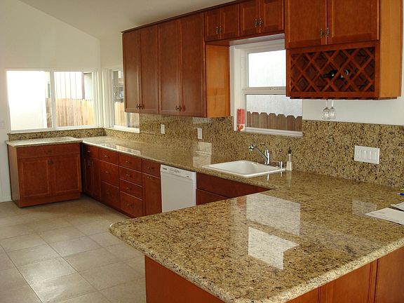 Kitchen with mobile island and cupboard. Peninsula dining area.