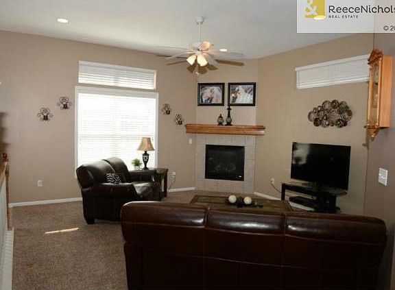 Living room with lots of sunlight and a cozy fireplace for winte
