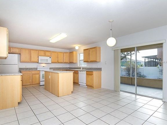 KITCHEN AND DINING AREA WITH VIEW OF LANAI