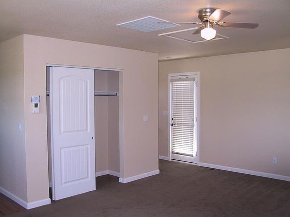 Main living/sleeping area of studio facing back door to deck and entry staircase.
