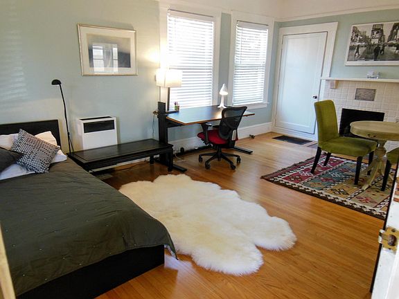 Open floor plan: queen bed, desk with 5G internet from Sonic, small dining area