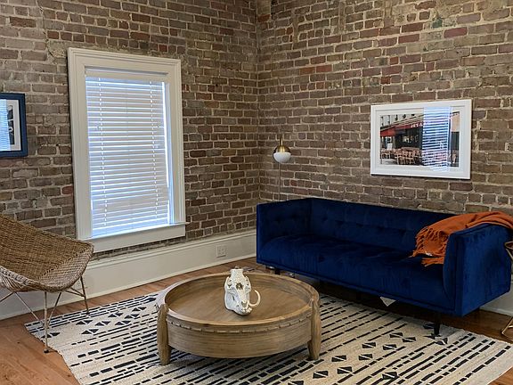 Living room space has lots of natural light from the 4 windows here