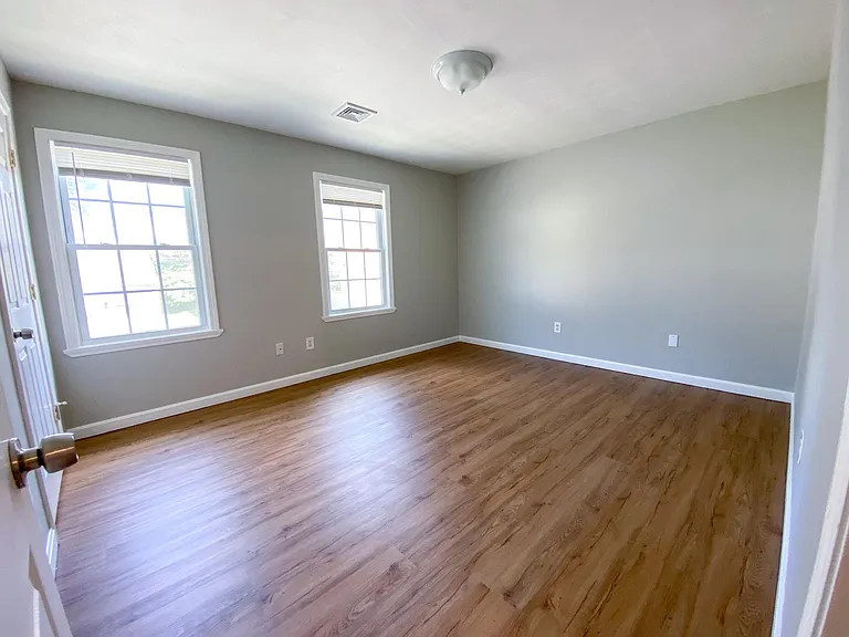 The primary bedroom with brand new paint & flooring!