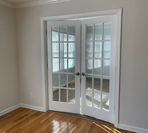 French doors off the front room enclose a private office.
