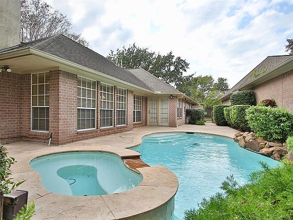 Backyard oasis with a sparkling pool & relaxing patio area.