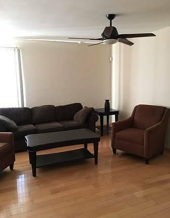 Living room has a couch, chairs, coffee table and side table