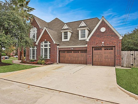 Take a look at the garage doors! And, if you love to entertain, look at the doublewide driveway which can fit lots of cars.