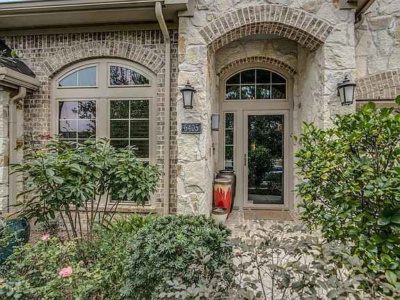 Tinted storm door. Gorgeous brick and stone.
