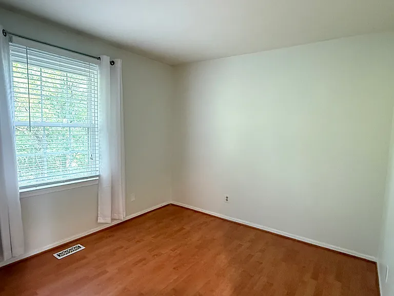 Freshly painted 2nd bedroom. View of parkland and creek.