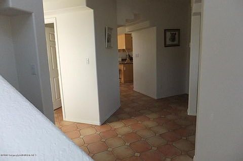 The hallway from the foyer leads to the private living room