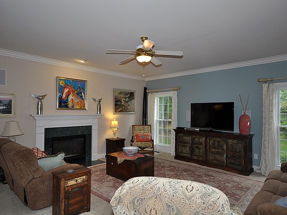 Foyer leads you to this warm living area .