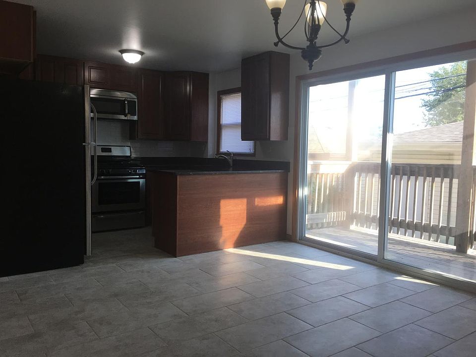 Kitchen leads to private balcony via sliding glass patio door