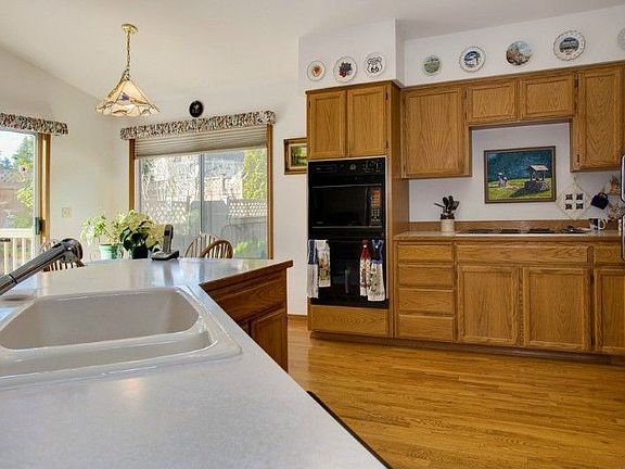 Kitchen opens to family room & dining area for more casual living. Vaulted ceilings & wood floors add to the charm! All appliances including washer & dryer, freezer in garage & 2 a/c units stay!