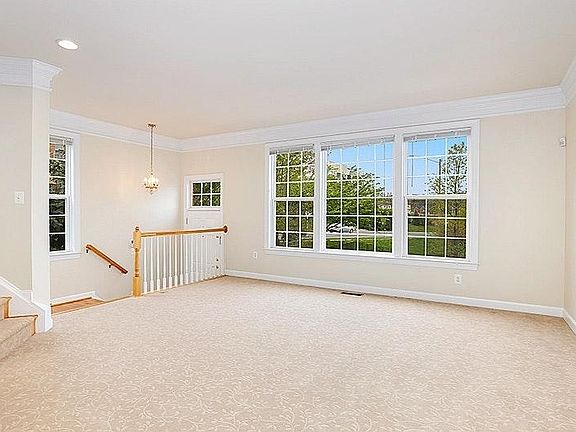 Living room has a designer carpet, well-lit with huge windows and beautiful view of a well-maintained lawn almost private with no homes across. You can see school bus-stop. It is close-enough to see your kids take the bus without having to leave your home