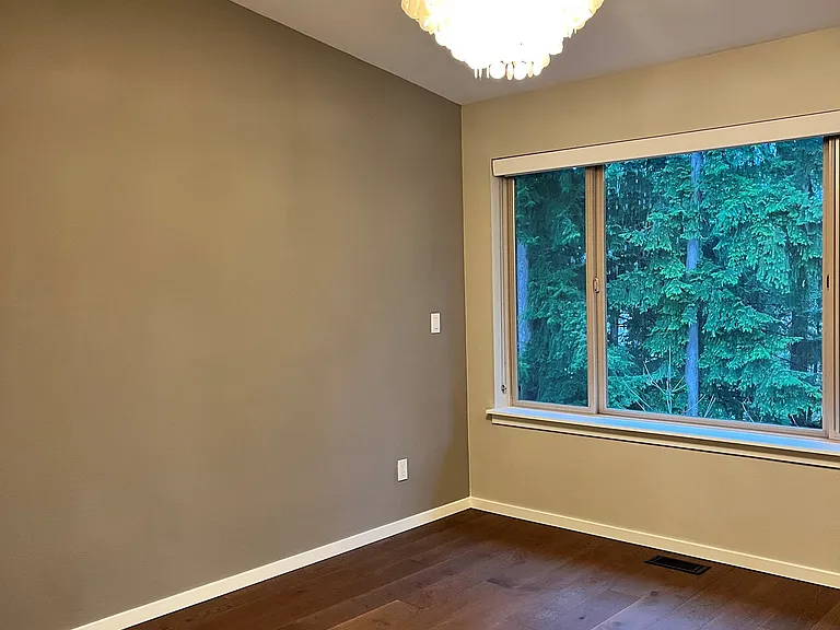 Master bedroom with chandelier, green belt view, large walk-in closets, hardwood throughout
