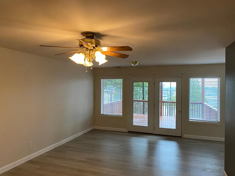 Bottom floor rec room or bedroom
Double doors lead out to lower level deck