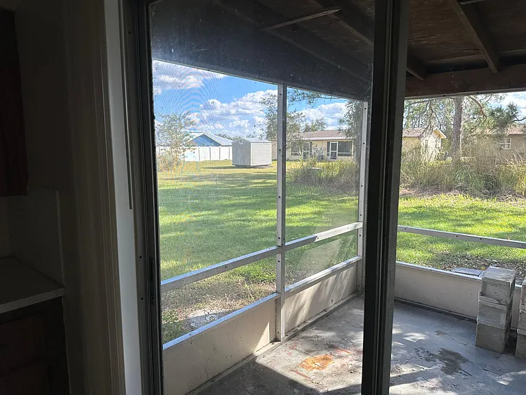 Screened in back porch has a closet with washer and dryer hookups.