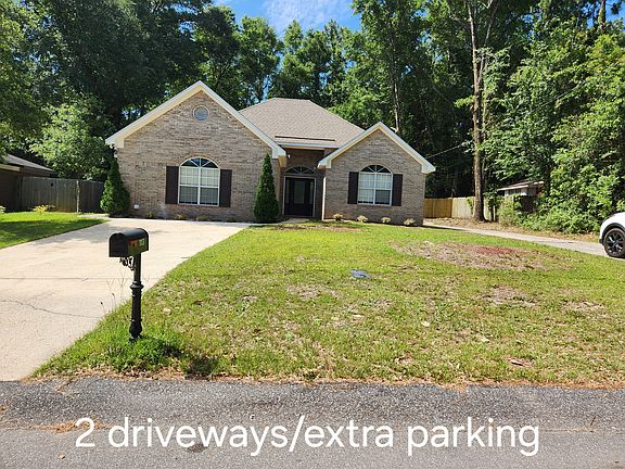 Front of beautiful brick home with two driveways.