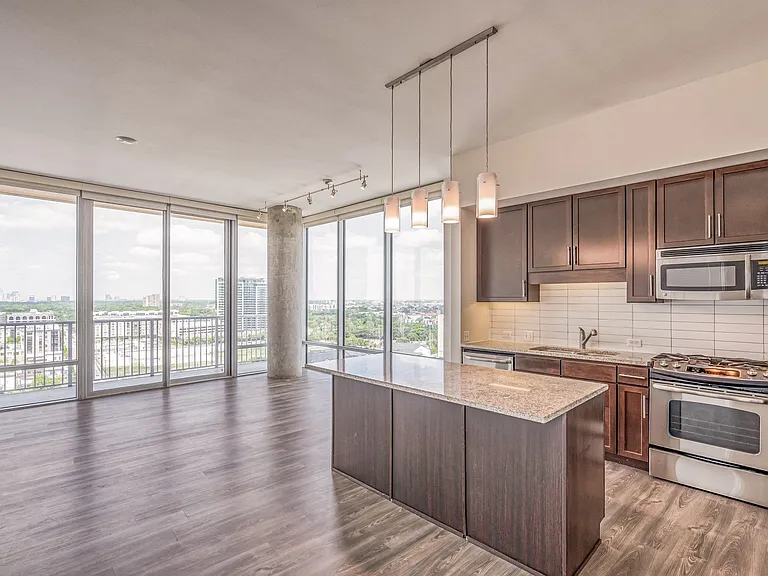 Open concept living and dining areas offer an abundance of space along with floor to ceiling windows