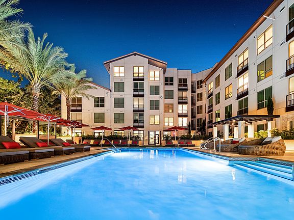 Resort-style pool with a collection of lounges and seating areas