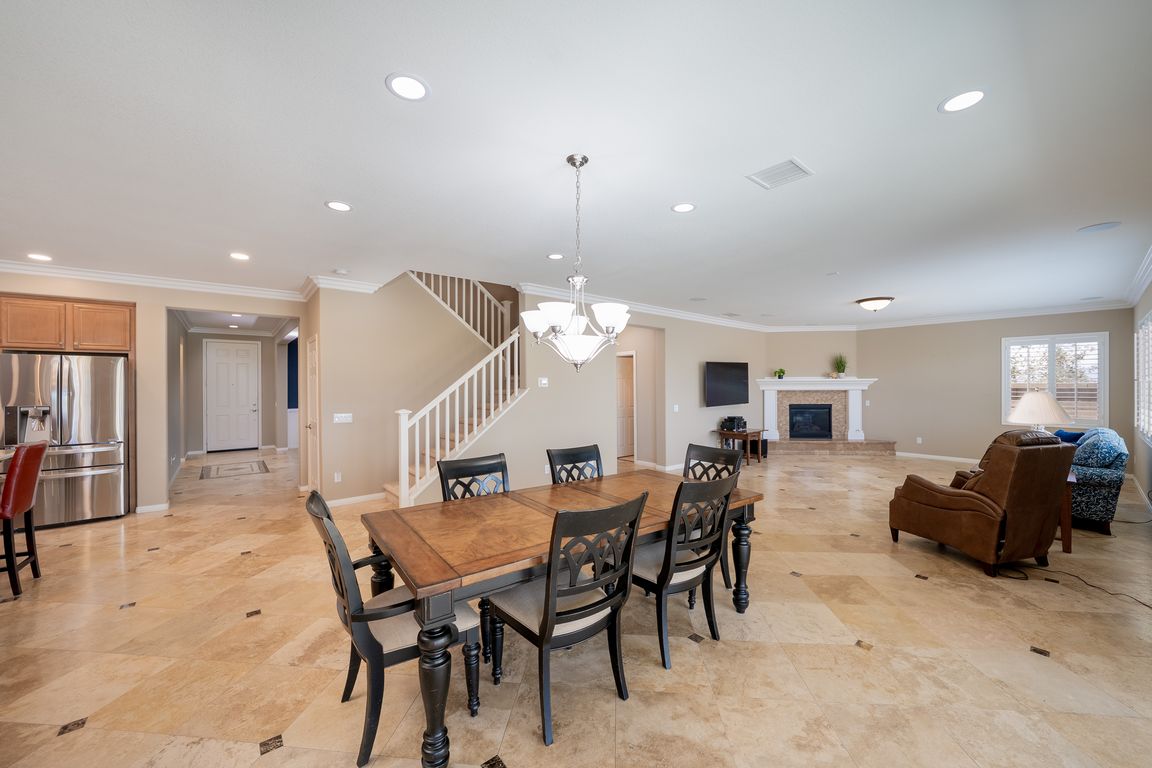 Open dining and family room with travertine flooring at 12881 Seahorse Drive