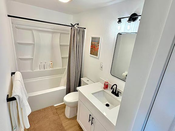 Shared Bathroom: Bright, newly renovated bathroom with a spacious vanity and fresh towels.