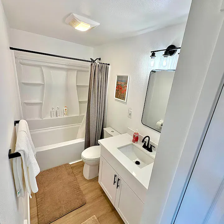 Shared Bathroom: Bright, newly renovated bathroom with a spacious vanity and fresh towels.