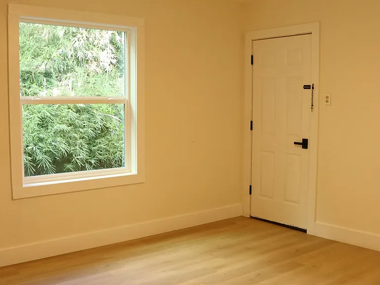 Large primary bedroom with natural light.