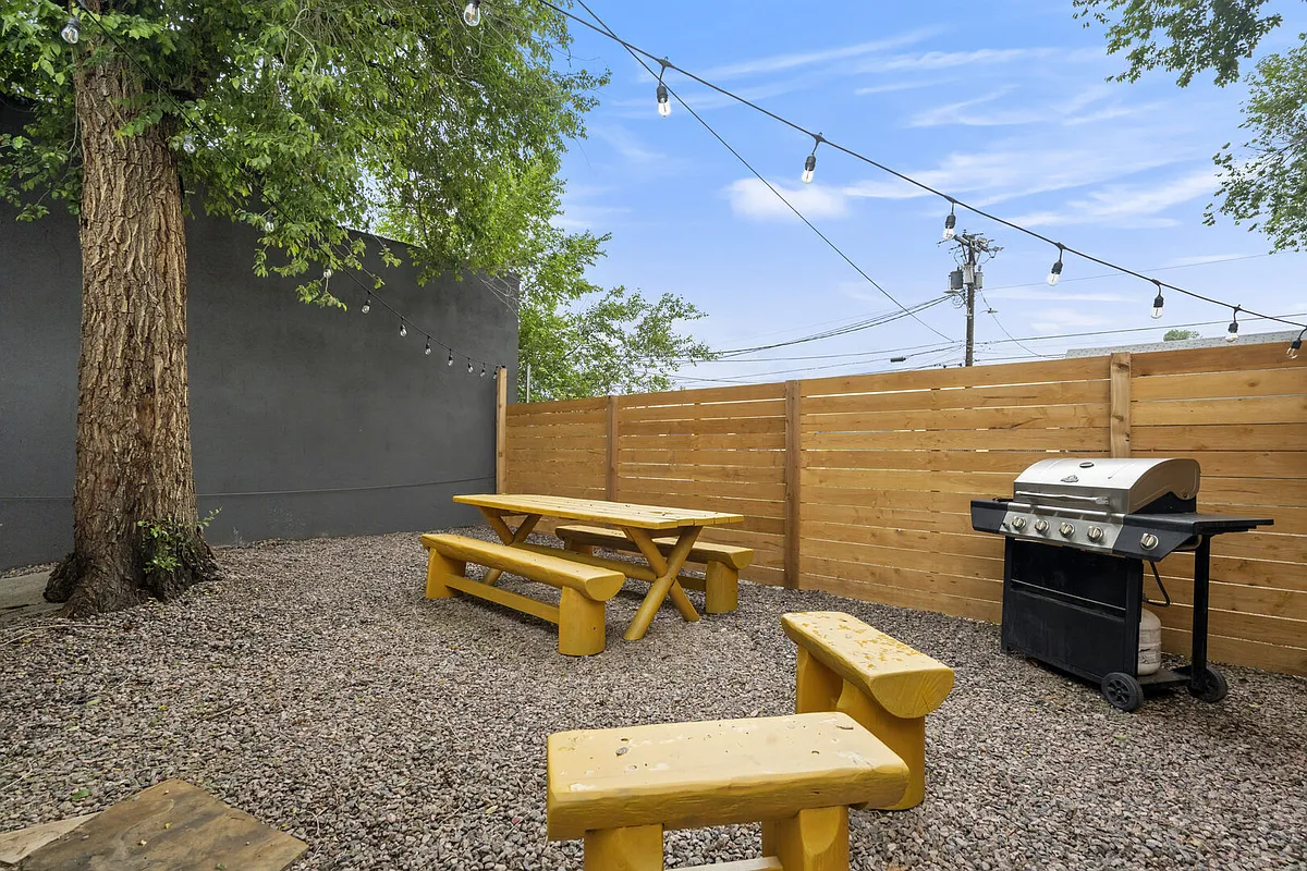 Enjoy your own fully fenced backyard with string lights, perfect for relaxing evenings or morning coffee. - S Tejon St