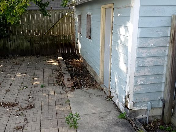 Part of the backyard has pavers for your picnic table.