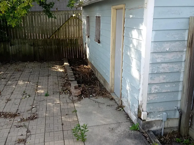 Part of the backyard has pavers for your picnic table.
